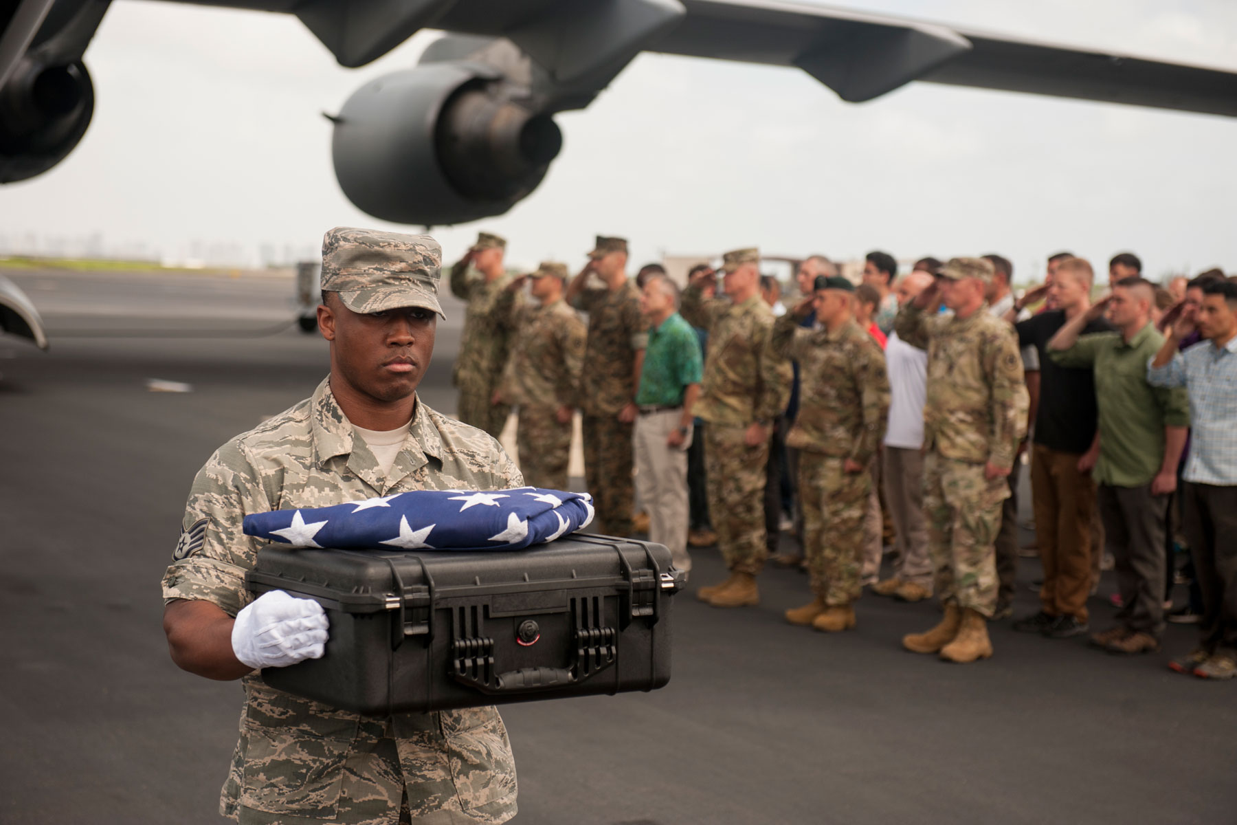 U.S. Air Force Staff Sgt. Sedric Franklin, an analyst with the Defense POW/MIA Accounting Agency (DPAA), carries a transfer case during a solemn movement at Joint Base Pearl Harbor-Hickam, Hawaii, April 15, 2018. (U.S. Air Force photo by Staff Sgt. Matthew J. Bruch)
