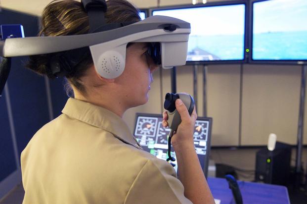 A Surface Warfare Officer's School (SWOS) student navigates a virtual vessel through a number of simulated hazards in the school's full-mission bridge. (U.S. Navy/Mass Communication Specialist 2nd Class Jason McCammack)
