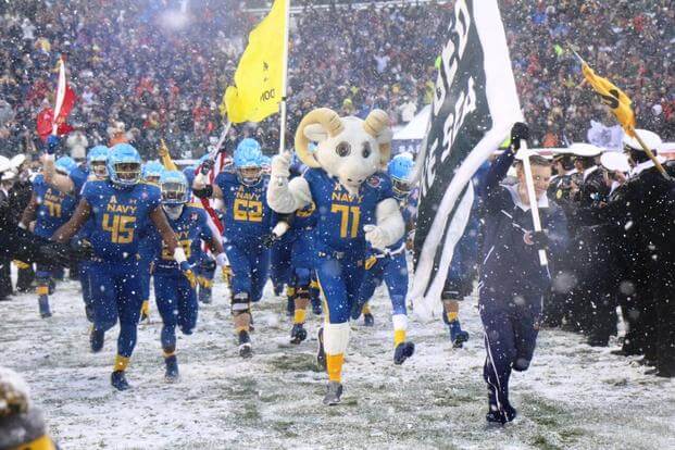 Navy's football team ran onto the field before the 118th Army-Navy Game. (Photo by Steve Whitman/Military.com)
