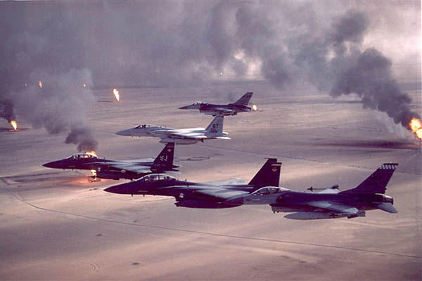 F-16A, F-15C and F-15E aircraft fly over Kuwaiti oil fires set by the retreating Iraqi army during Desert Storm. (U.S. Air Force/Fernando Serna)