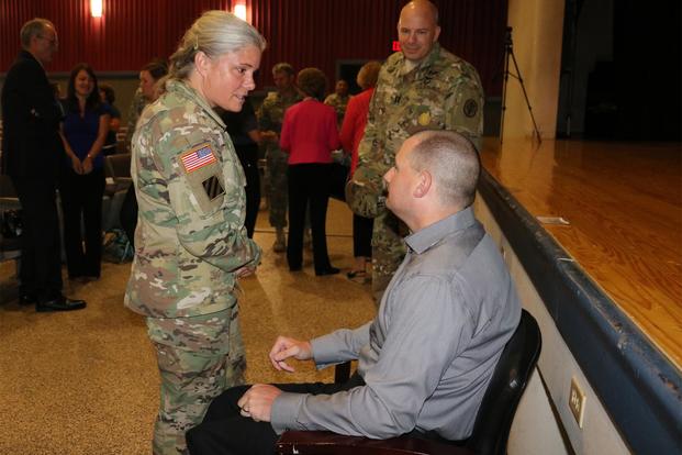 FILE -- Command Sgt. Maj. Staci Rea thanks then Cpl. Matthew Bradford following the telling of his personal story of overcoming amputations and blindness, Sept. 29, 2016. Bradford will be one of three service members invited to attend the 2018 State of the Union Address. (Laura Boyd/U.S. Army )