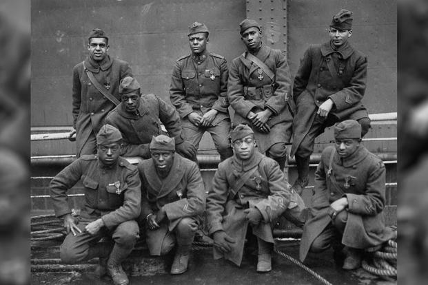 Some of the members of the 369th (15th N.Y.) Who won the Croix de Guerre for gallantry in action. Left to right. Front row: Pvt. Ed. Williams, Herbert Taylor, Pvt. Leon Fraitor, Pvt. Ralph Hawkins. Back row. Sgt. H. D. Prinas, Sgt. Dan Storms, Pvt. Joe Williams, Pvt. Alfred Hanley, and Cpl. T.W. Taylor; 1919 (National Archives/Unknown Photographer)