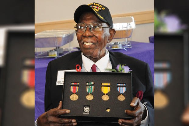 Richard Bell, a 99-year-old veteran and Blackstone resident, poses for pictures with medals he earned more than 72 years ago in World War II during a family reunion event Aug. 26, 2017, at the Eastern Henrico Recreation Center. (U.S. Army/Terrance Bell)