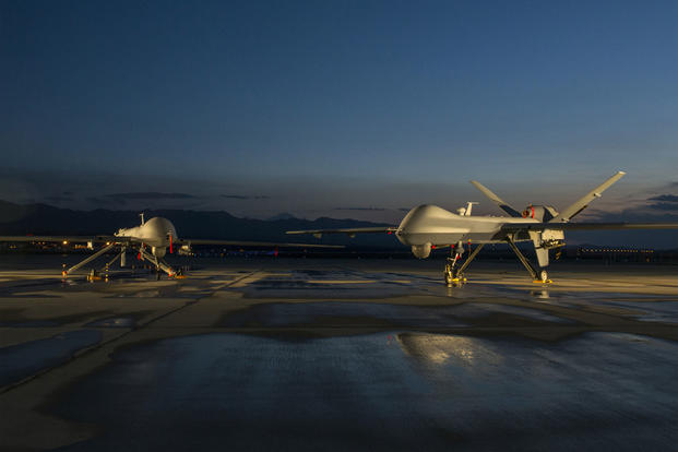 An MQ-1 Predator drone (left) and MQ-9 Reaper drone assigned to the 432nd Aircraft Maintenance Squadron remain ready for their next mission at Creech Air Force Base in Nevada. (US Air Force photo)