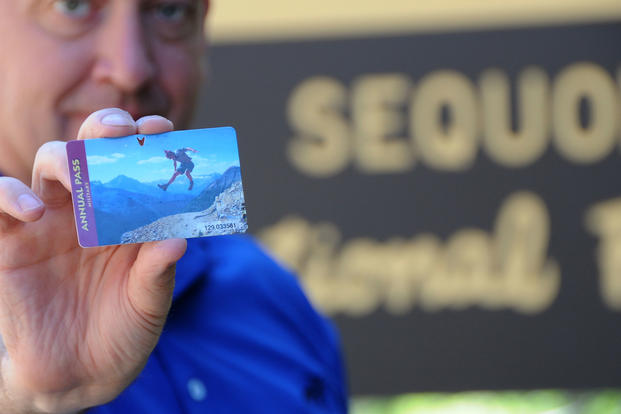 Master Sgt Vincent De Groot, of the Iowa Air National Guard, displays an Annual Pass to the National Parks he picked up during a recent visit to Sequoia National Park in California. (U.S. Air Force) 