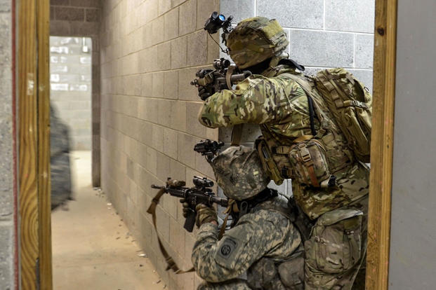 Paratroopers assigned to Alpha Company, 1st Battalion, 508th Parachute Infantry Regiment provide security in a hallway during an urban air assault exercise at Fort A.P. Hill, Va., on March 20. (US Army photo/John Lytle)