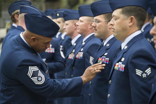 Chief Master Sgt. Gerard Crump, 85th Engineering Installation Squadron, inspects the uniform of Staff Sgt. Bryant Horton, 85th EIS, during a squadron open ranks inspection Nov. 25, 2013. (U.S. Air Force/Adam Bond)