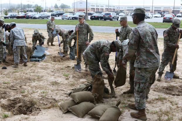 3rd Expeditionary Sustainment Command Soldiers fill sandbags in preparation for Hurricane Florence at Fort Bragg, North Carolina, September 12, 2018. (U.S. Army/Staff Sgt. Terrance Payton)