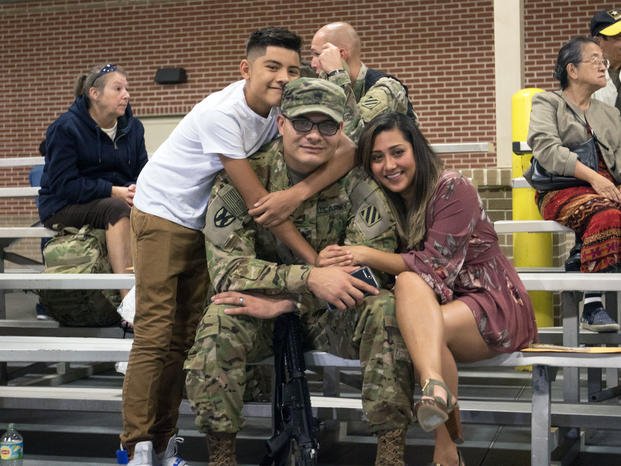 Family embrace their Soldier of 3rd Infantry Division Sustainment Brigade minutes prior to his departure. (U.S. Army/Candace Mundt)