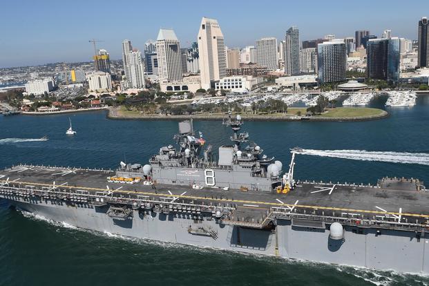 Sailors and Marines stationed and embarked aboard USS Makin Island (LHD 8) man the rails of the amphibious assault ship as they pass by downtown San Diego to begin their scheduled 7-month deployment. (U.S. Navy/Petty Officer 1st Class Jason J. Perry)