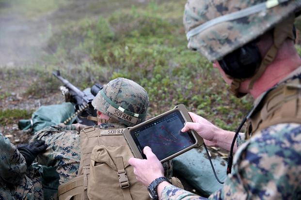 A U.S. Marine with Marine Rotational Force-Europe 18.1 uses a Marine Air Ground Task Force Common Handheld to direct machine gun fire during a platoon-supported attack range at Giskas, Norway, Aug. 7, 2018. (Photo: Marine Corps)
