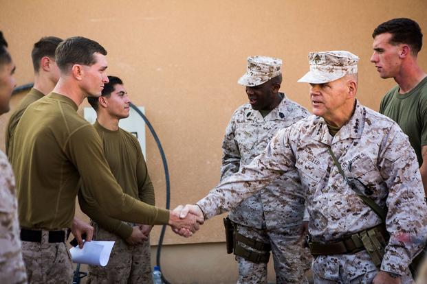 FILE -- In Dec. 21, 2015 file photo, U.S. Marine Gen. Robert B. Neller, 37th commandant of the Marine Corps, and Sgt. Maj. Ronald Green, 18th Sergeant Major of the Marine Corps, visit Marines with with 1st Battalion, 7th Marine Regiment, Special Purpose Marine Air Ground Task Force - Crisis Response - Central Command at Al Asad Air Base, Iraq. During their visit to the U.S. Central Command area of responsibility, the leaders addressed Marines and sailors on matters concerning the future of the Corps and wis