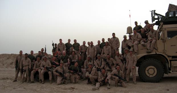 FILE -- In in this Jan. 1, 2004 file photo, Marine Sgt. Charlie Brown (seated on the truck third from right), a Data Network Specialist with 2nd Marine Logistics Group (Forward), deployed to Iraq with the Marines of Weapons Platoon, Kilo Company, 3rd Battalion, 1st Marine Regiment, who took time to pose for a photo during their 2005 deployment in Iraq. Brown is currently serving in Afghanistan on his sixth deployment. ( Katherine Solano/U.S. Marine Corps)