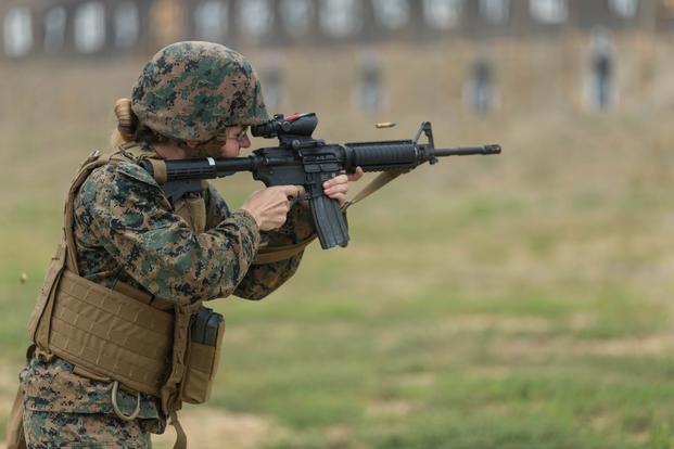 A female Marine fires an M4 carbine rifle at Wilcox Rifle Range. 