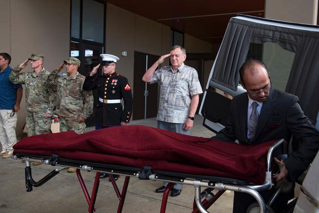 Members of the Defense POW/MIA Accounting Agency (DPAA) render honors as a mortician from a local funeral home prepares the remains of U.S. Army Cpl. Albert Mills for transport at Joint Base Pearl Harbor-Hickam. (Tech. Sgt. Kathrine Dodd/U.S. Air Force photo)