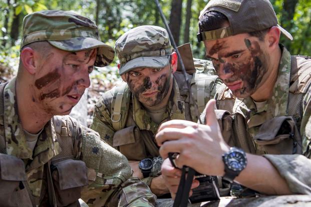 Airmen communicate with rescue forces with a radio during a survival, evasion, resistance, and escape exercise.