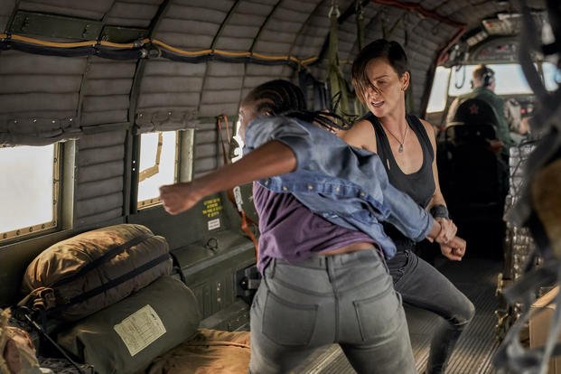 KiKi Layne and Charlize Theron square off in an airborne plane in "The Old Guard." (Aimee Spinks/NETFLIX)