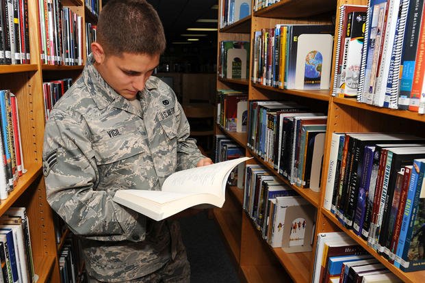 Senior airman looks through college exam book