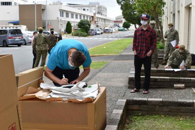 NAVSUP Fleet Logistics Center Yokosuka household goods team assists sailors.