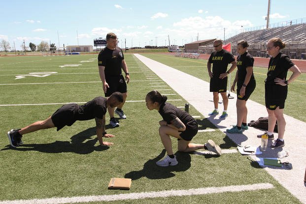 An instructor shows soldiers on how to do proper hand-release push-ups.