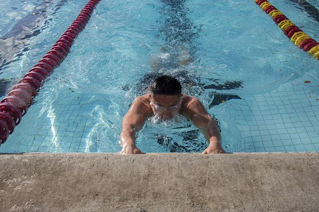 A Marine completes a 50-meter swim.
