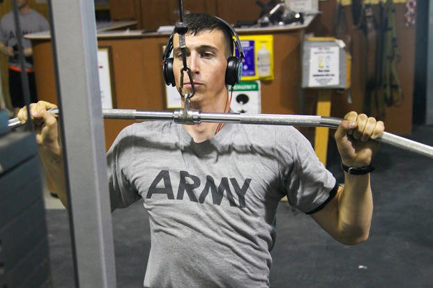 A soldier works on the lat pulldown machine.