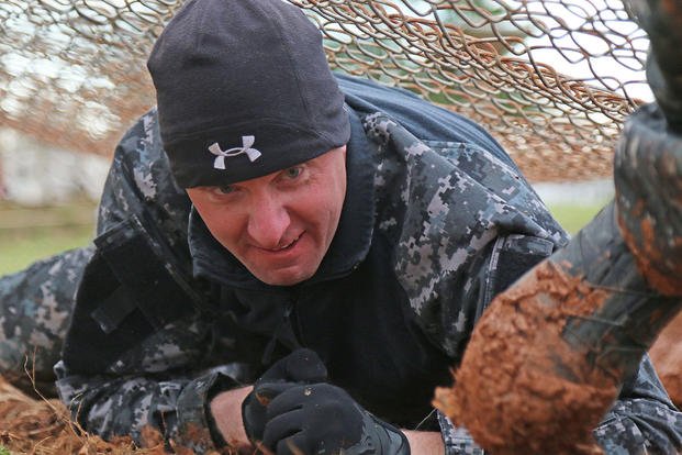 A Clarksville, Tennessee, law enforcement officer conducts the low-crawl obstacle course during the SWAT Challenge at Fort Campbell, Kentucky. 