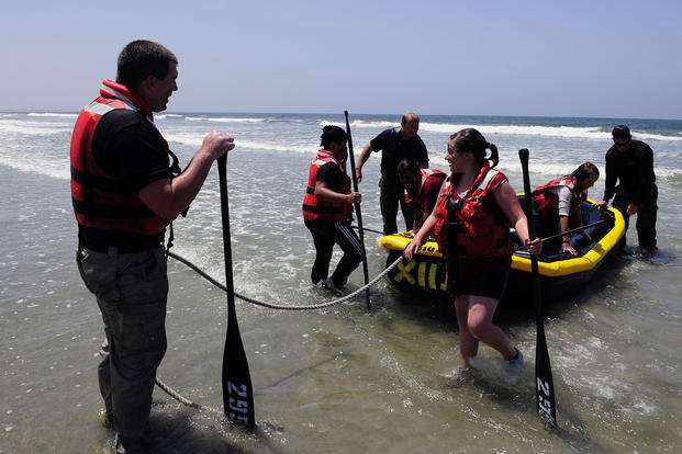 Students, police officers and Naval Special Warfare Center instructors participate in a Day with the Navy SEALs.