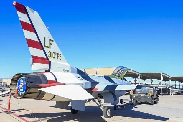 The 310th Fighter Squadron’s newly painted F-16 Fighting Falcon is towed to the flight line Jan. 19, 2022, at Luke Air Force Base, Arizona. Structural maintainers applied a paint scheme to match that of the World War II era 310th Fighter Squadron’s “Passionate Patsy” Republic P-47 Thunderbolt in celebration of the Air Education and Training Command’s 80th anniversary. (U.S. Air Force photo by Senior Airman David Busby) F-16 Fighting Falcon with WWII paint scheme of Republic P-47.
