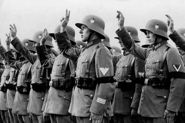 German Reichswehr soldiers wearing WWI-era Stahlhelm during the swearing-in ceremony of German leader Adolf Hitler in 1933. (German Federal Archives)