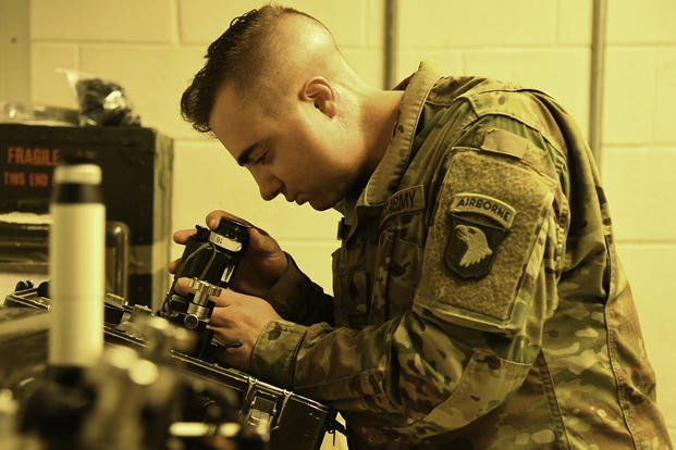 Spc. Joseph Calabreth tests a 4th Infantry Division Soldiers AN-PVS14 night vision monocular device for defaults and emission points in Afghanistan. 