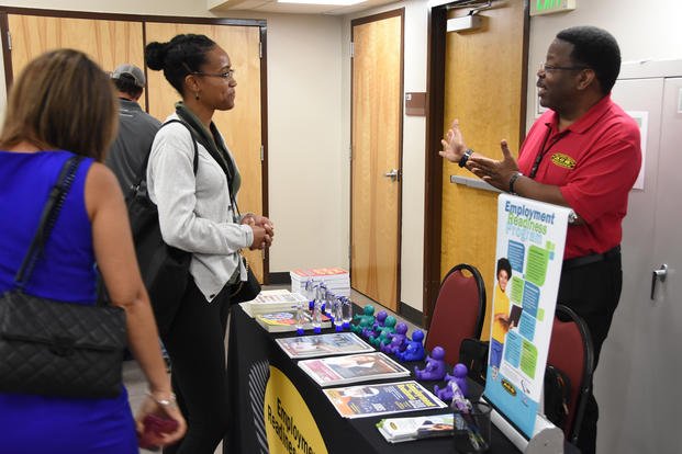 Attendees discuss employment and the job search process with a career counselor at Pope Field at Fort Bragg, N.C.