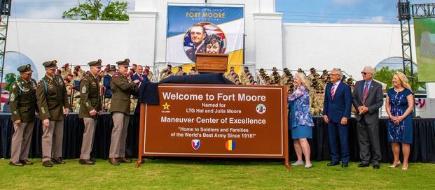 Fort Moore leaders, along with members of the Moore family (at right), unveil an official Fort Moore sign during a redesignation ceremony May 11 held at the post’s historic Doughboy Stadium.