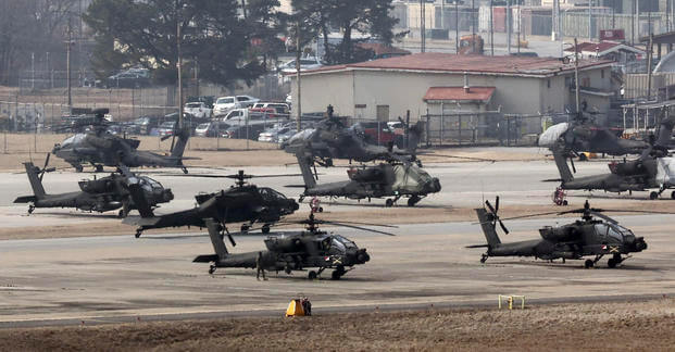 U.S. Army Apache helicopters take off at Camp Humphreys in Pyeongtaek, South Korea