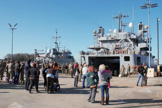 Families of soldiers gather around the pier at Fort Eustis, Virginia