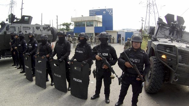 Police stand guard at the entrance of a penitentiary in Guayaquil, Ecuador.