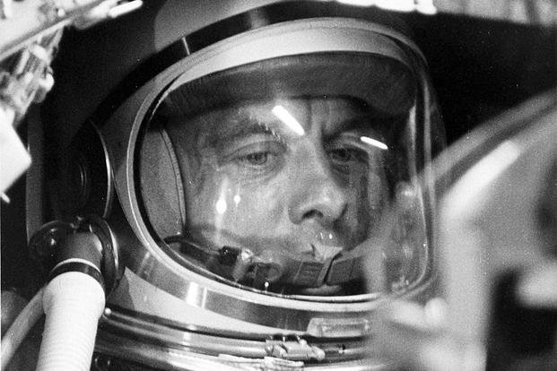 A closeup of astronaut Alan Shepard in his space suit seated inside the Mercury capsule. He is undergoing a flight simulation test with the capsule mated to the Redstone booster.