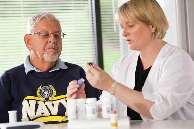 Navy veteran in consultation with his nurse. (Photo: Department of Veterans Affairs)
