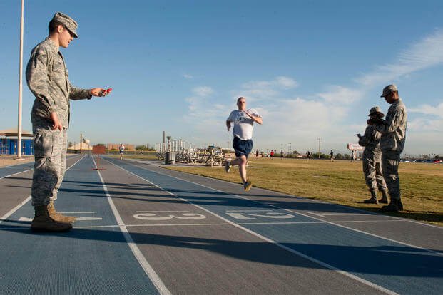 A service member finishes the run portion of his Air Force physical fitness test.