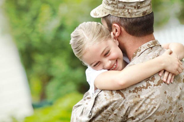 Serviceman hugging daughter