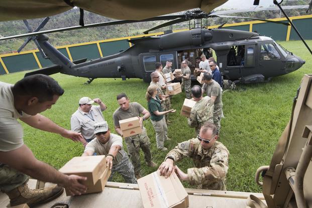 U.S. Army Lt. Gen. Jeff Buchanan, commander of Joint Task Force Puerto Rico, and soldiers from the Puerto Rico National Guard unload a UH-60 Blackhawk helicopter carrying critical supplies in Jayuya, Puerto Rico on Oct. 11, 2017. DoD photo