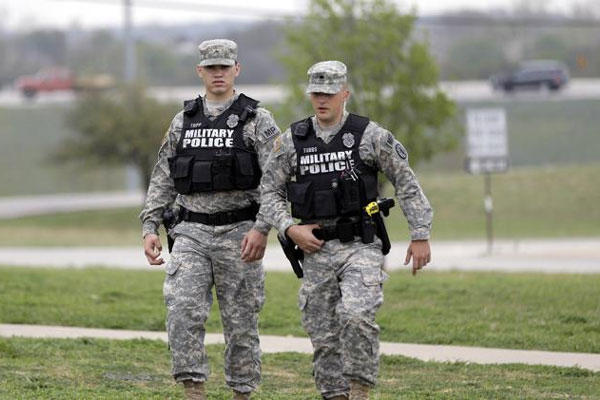 Military police patrol near Fort Hood's main gate, Thursday, April 3, 2014, in Fort Hood, Texas. (AP Photo/Eric Gay)