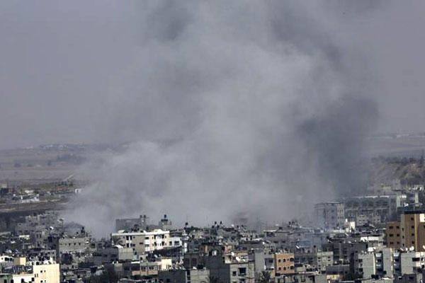 Smoke from Israeli strikes rises over Gaza City, in the northern Gaza Strip, in the northern Gaza Strip, Wednesday, July 30, 2014. (AP Photo/Adel Hana)