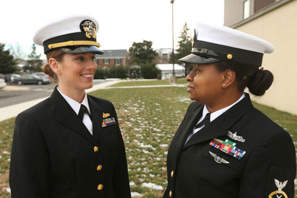 Lt. Heidi Boettger and Chief Petty Officer Brianne Dentson model a prototype for the female combination cover, redesigned to more closely resemble the male version. (Elliott Fabrizio/U.S. Navy)
