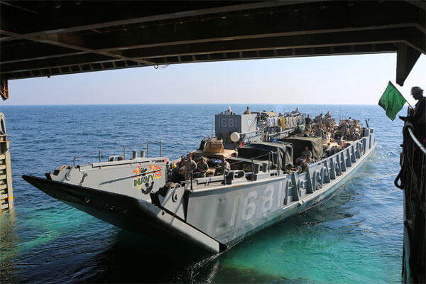 A landing craft utility exits the well deck of the amphibious dock landing ship USS Comstock to transport Marines and Sailors assigned to the 11th MEU and Comstock ashore. (U.S. Marine Corps photo by Sgt. Melissa Wenger/Released)