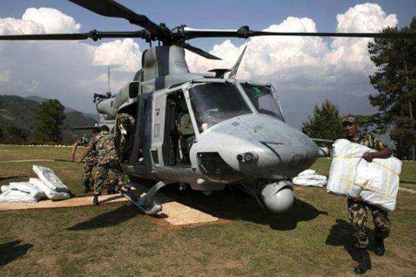 Nepalese military service members unload supplies from a UH-1Y Huey in Charikot, Nepal on May 5. (Marine photo)