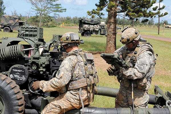 Soldiers adjust their M119A3 howitzer as they occupy a firing point on Area X-Ray during Exercise Lightning Forge in March. (U.S. Army/Sgt. Brian C. Erickson)