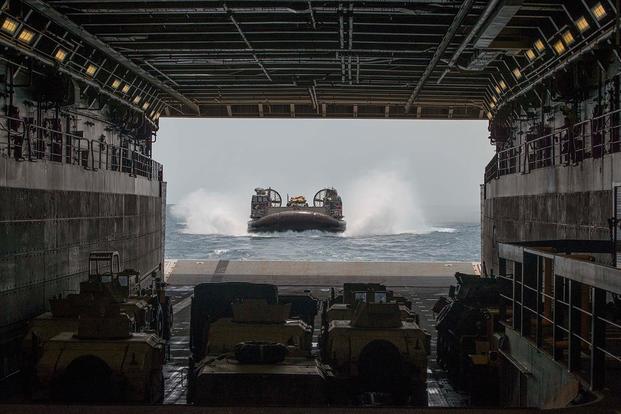 A landing craft air cushion (LCAC) attached to Assault Craft Unit (ACU) 5 enters the well deck of the San Antonio-class amphibious transport dock ship USS Anchorage (LPD 23).  (Photo by Mass Communications Specialist 2nd Class Matthew Dickinson)