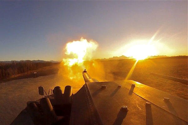 Flames erupt from the barrel of an M1128 Mobile Gun System as the sun sets over Alaska's Donnelly Training Area during the 1st Stryker Brigade Combat Team, 25th Infantry Division's MGS exercise Oct. 25, 2013. (Defense Department photo/Austin Buettgenbach)