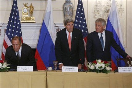 Secretary of State John Kerry, center, Defense Secretary Chuck Hagel, right, and Russian Foreign Minister Sergei Lavrov take their seats before making statements to reporters as they meet at the State Department in Washington, Friday, Aug. 9, 2013.